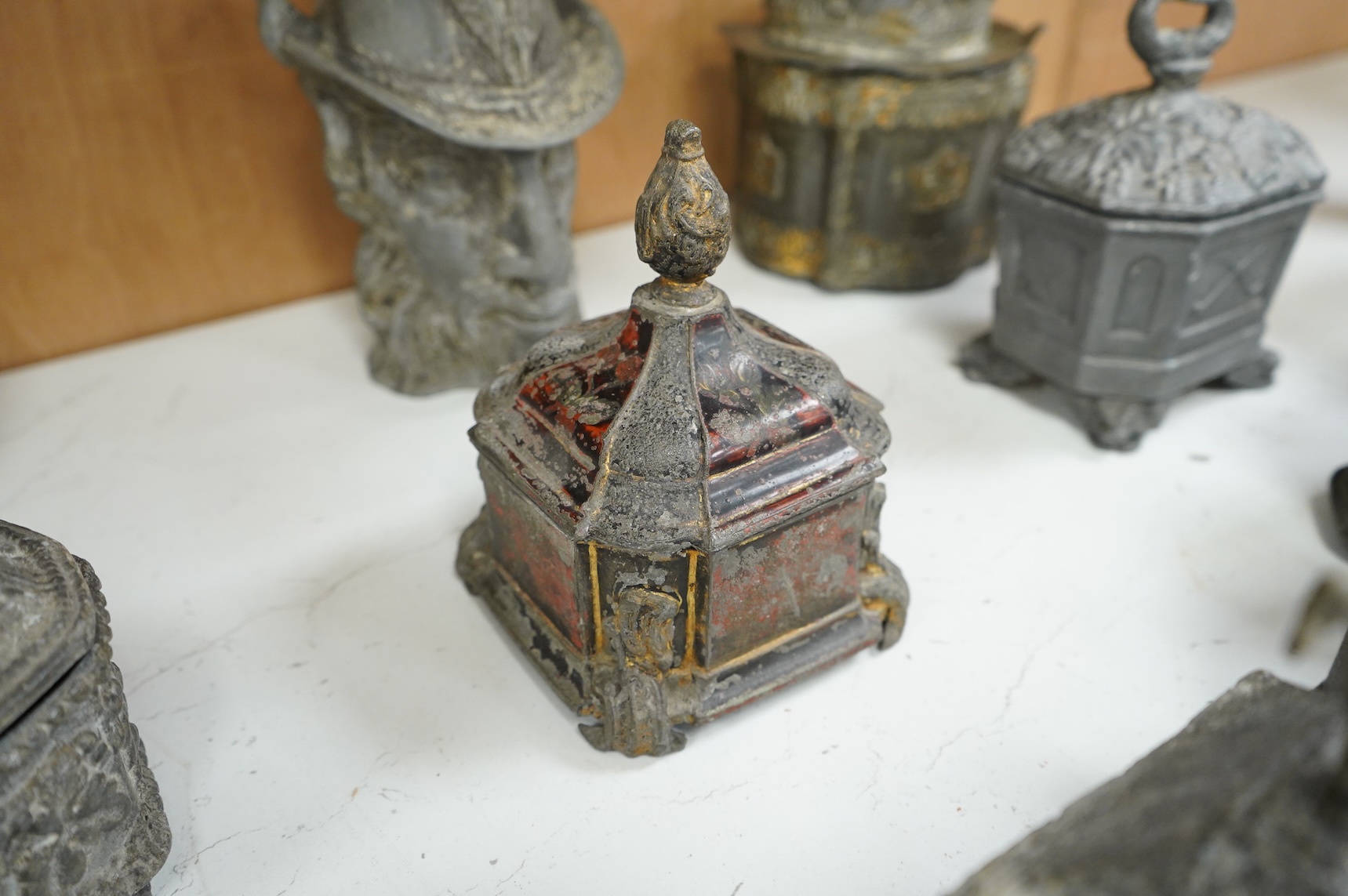A collection of ten early 19th century lead tobacco boxes, one in the form of a goat’s head, tallest 20cm